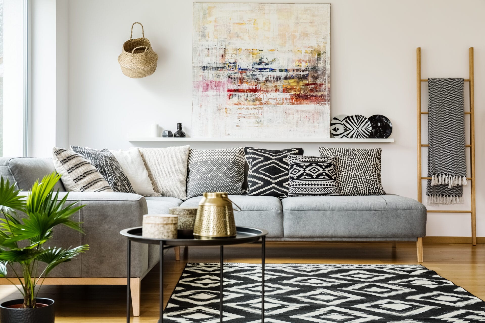 Patterned pillows on grey corner sofa in living room